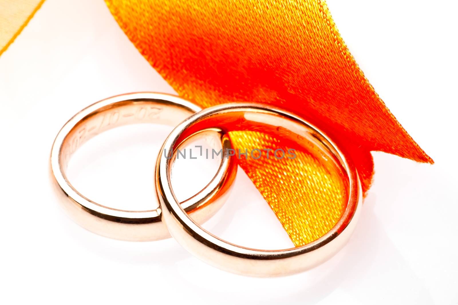 gold wedding rings near ribbon by donfiore