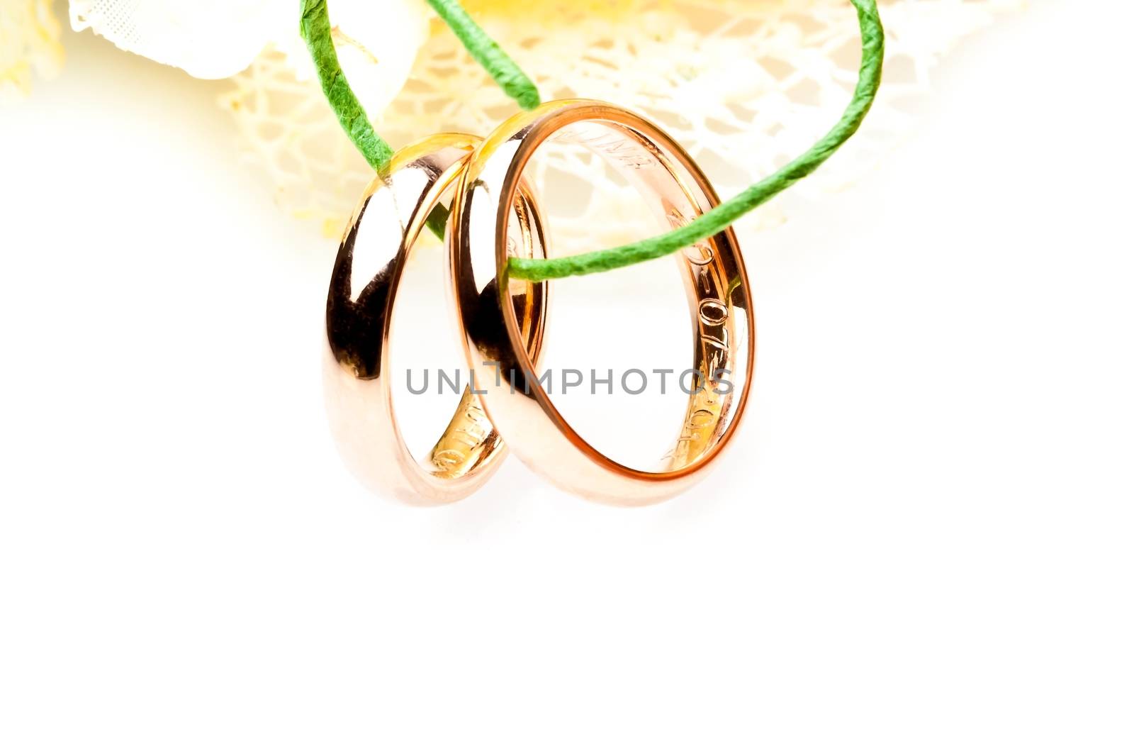 gold wedding rings near flowers with space for text by donfiore