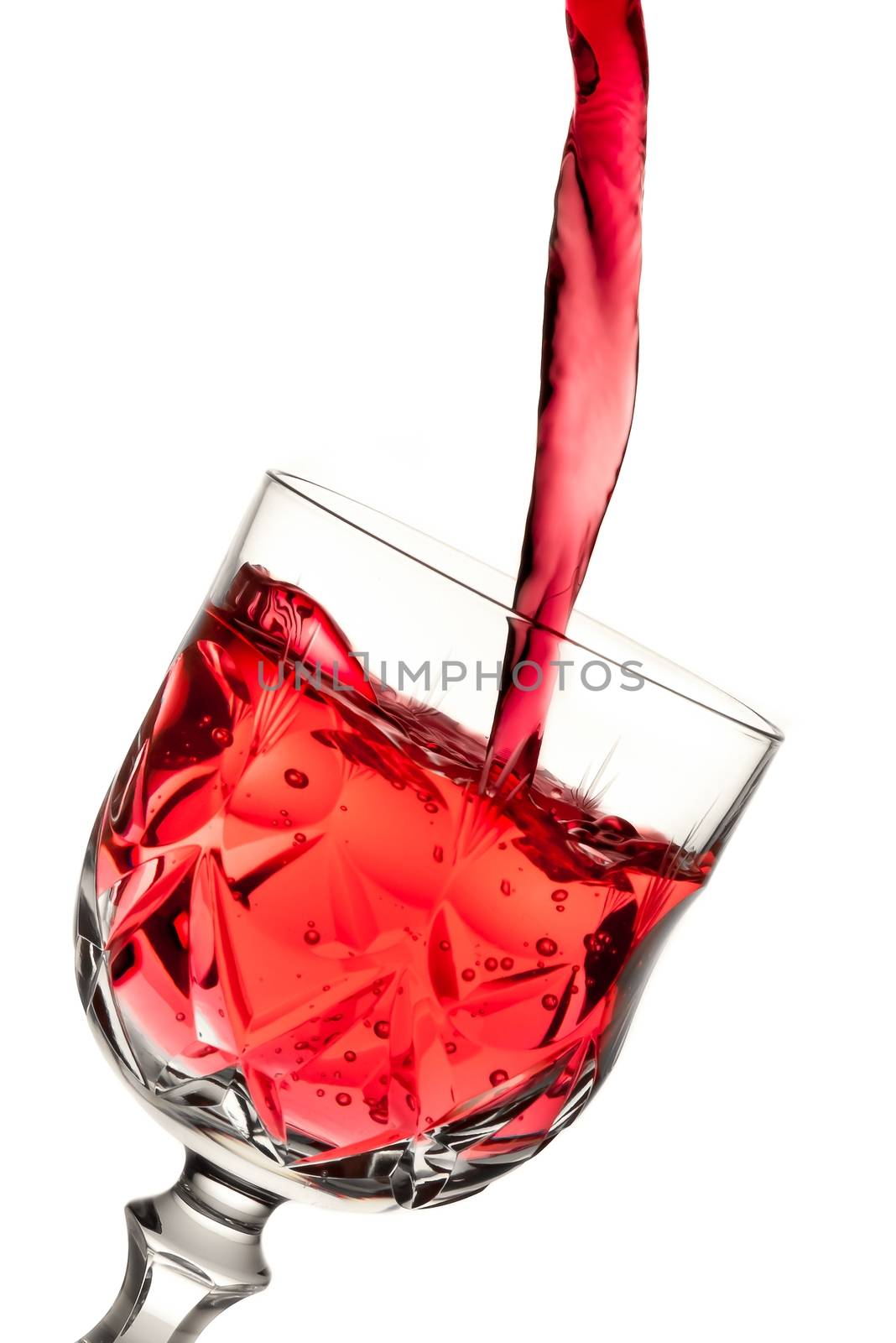 red wine pouring into glass by donfiore