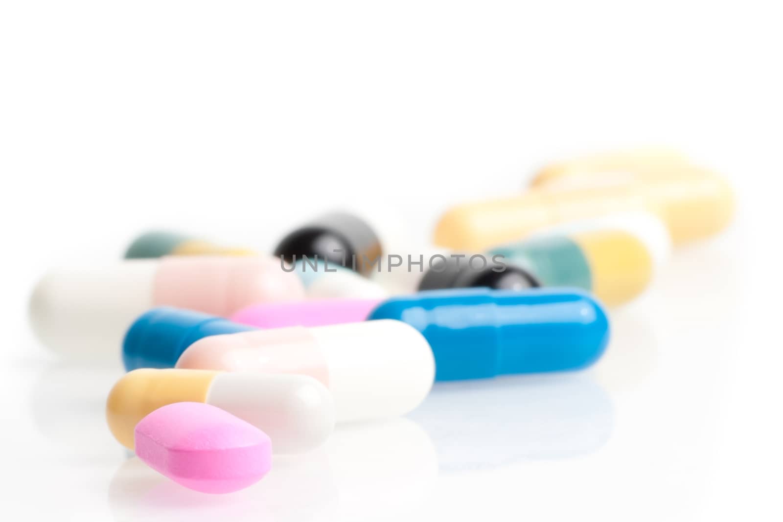 closeup of a lot of medical pills in laboratory on white table