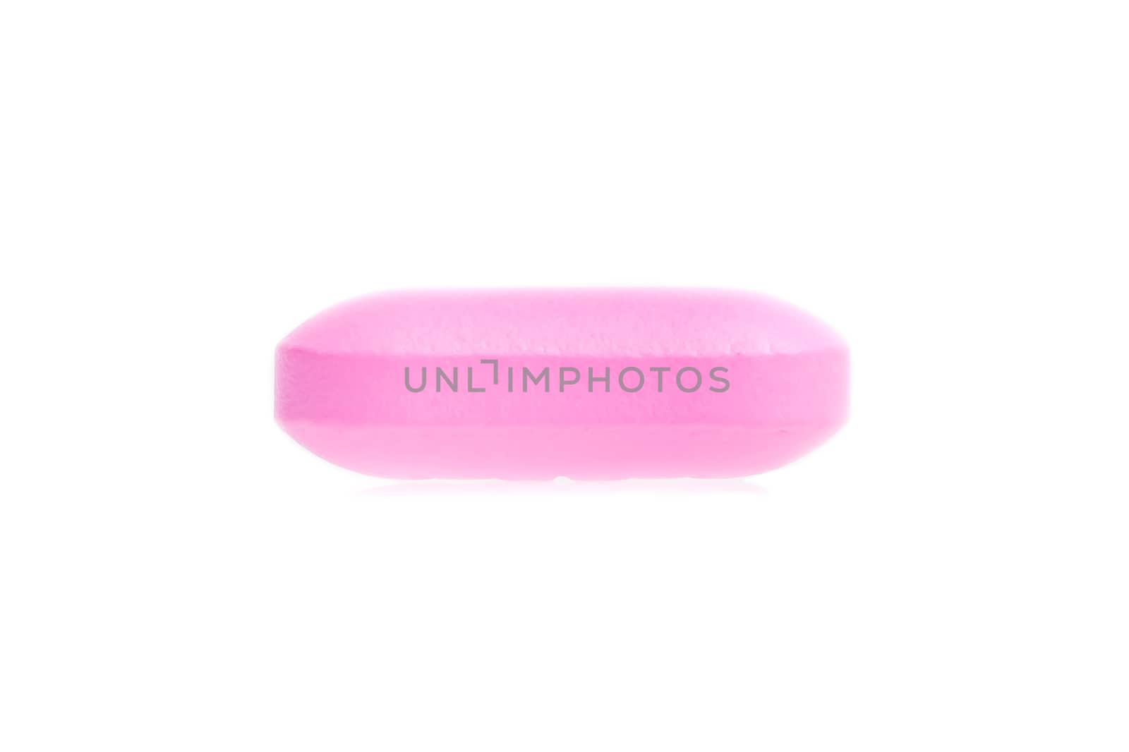 one pink medical pill isolated on white background