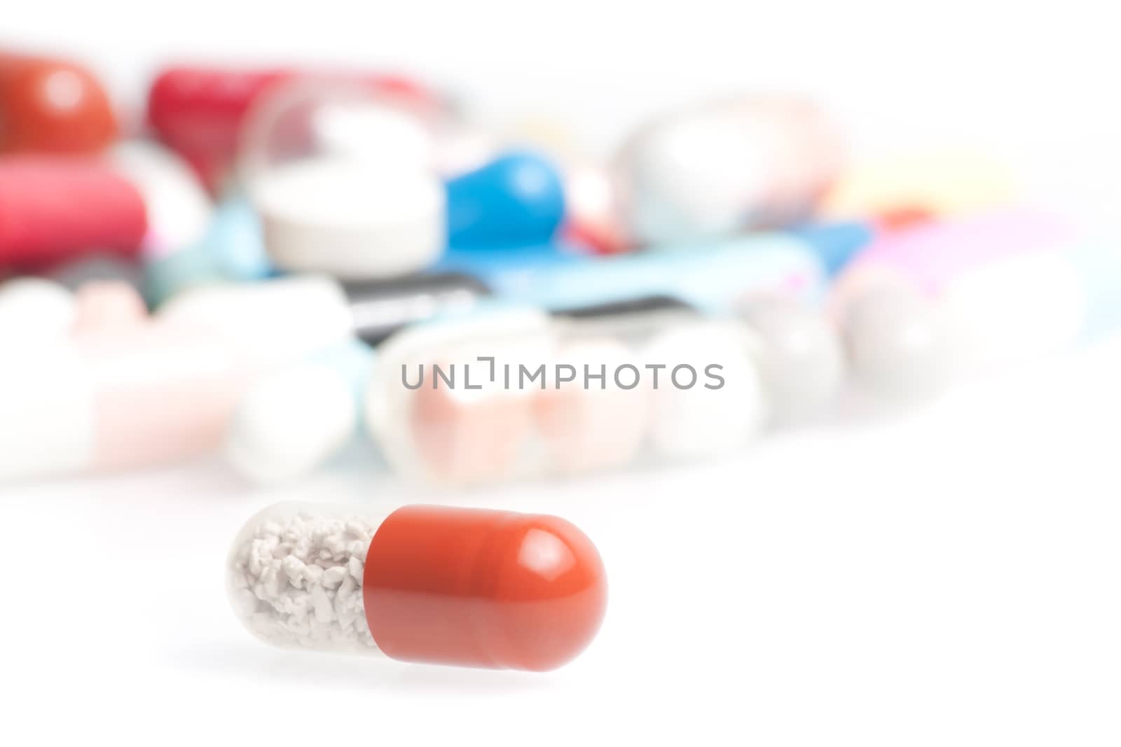 closeup of one medical pill in laboratory on white table