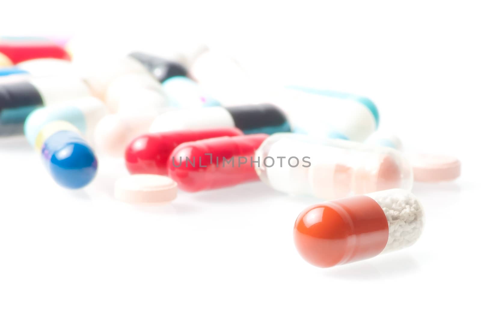 detail of one medical pill in laboratory on white background