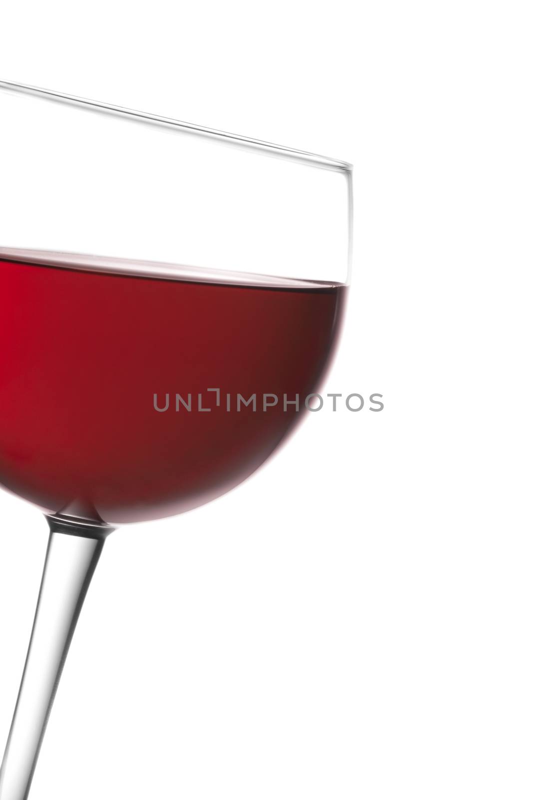 glass of red wine tilted with space for text on a white background