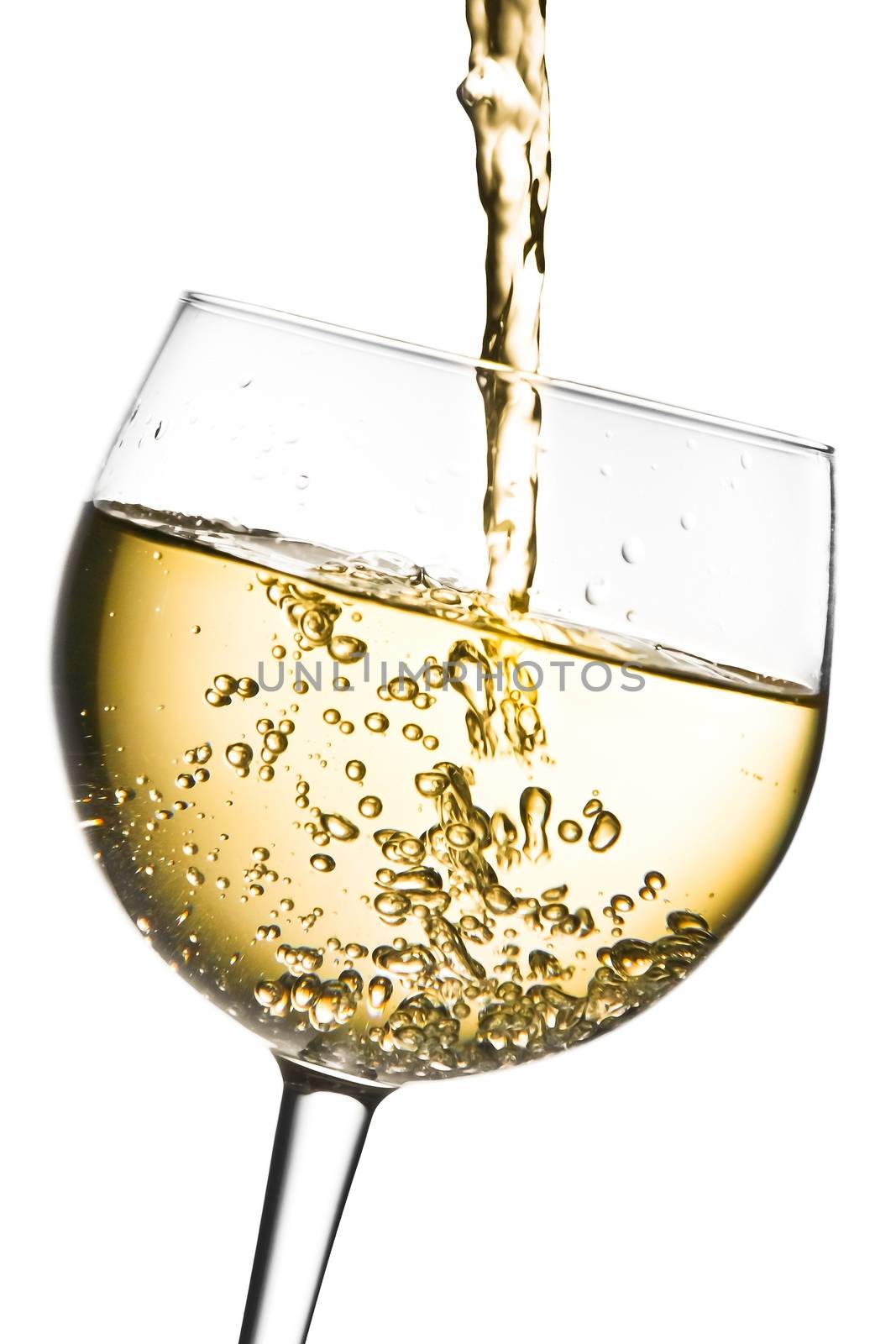 white wine pouring into glass tilted with space for text  by donfiore