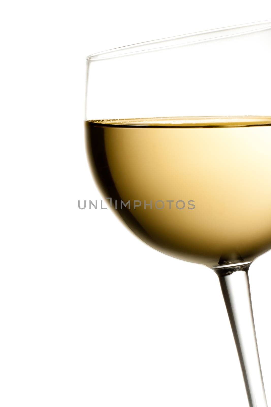 glass of white wine tilted with space for text on a white background