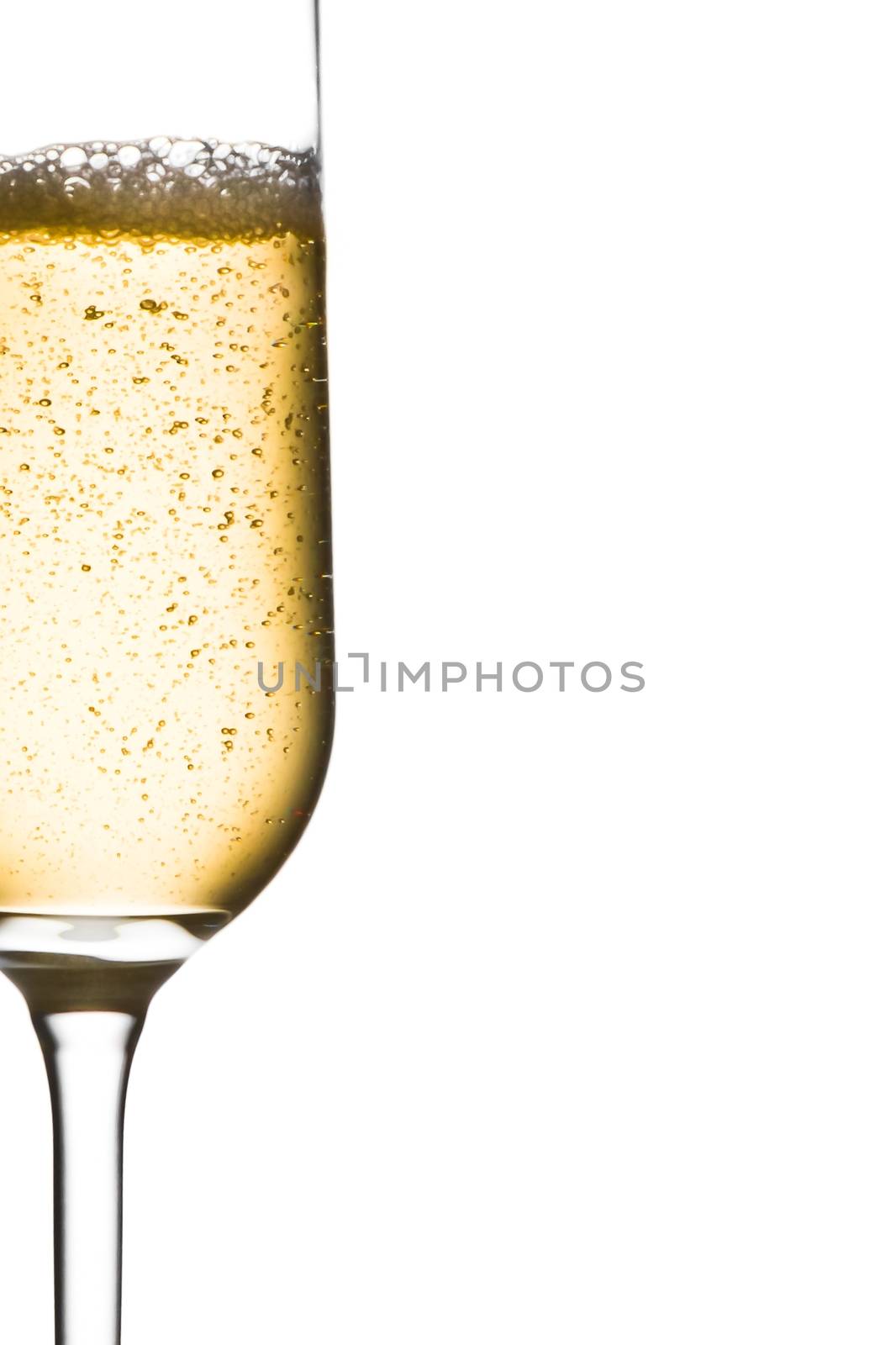 half glass of champagne with bubbles and space for text by donfiore