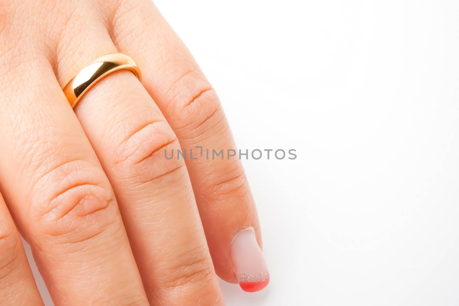 detail of one hand with gold ring with space for text on white background 