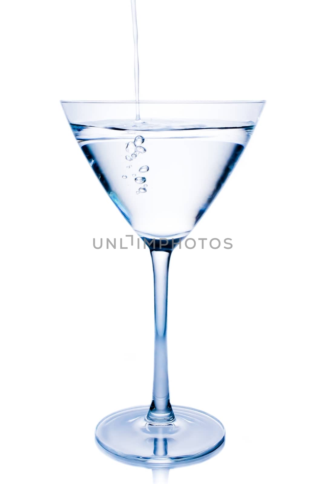 filling a  white cocktail in a glass with blue reflections  by donfiore