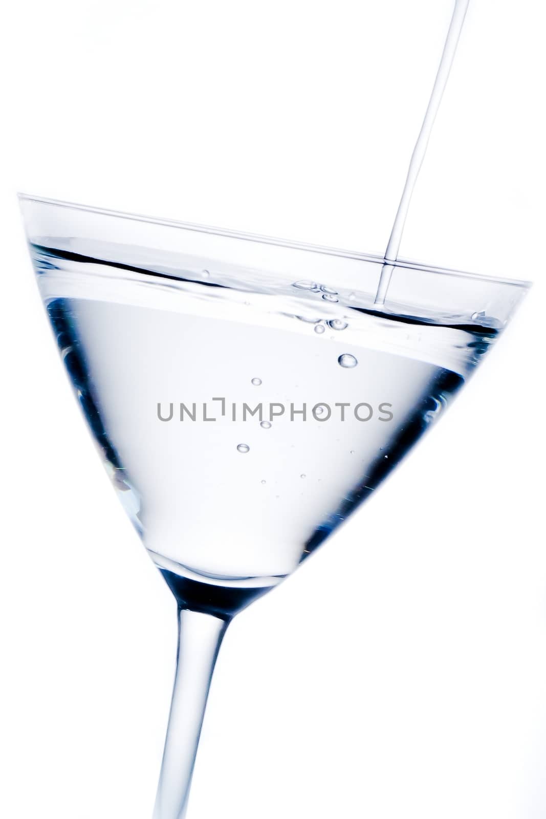 white cocktail with blue reflections on white background