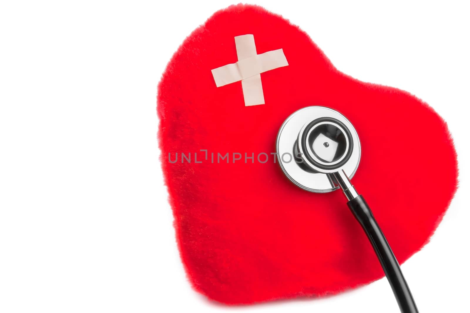 heart of cuddly toys with patch near stethoscope on white background with space for text