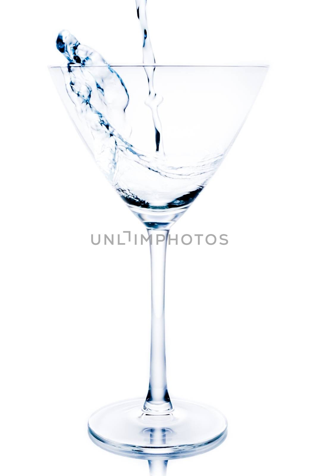 white cocktail with blue reflections and splashing on white background
