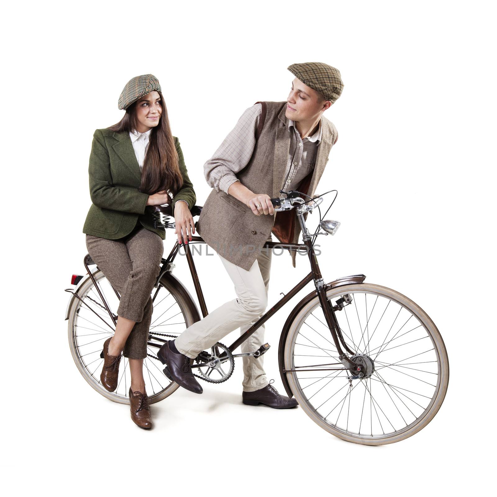 Vintage dressed couple sitting on retro bike