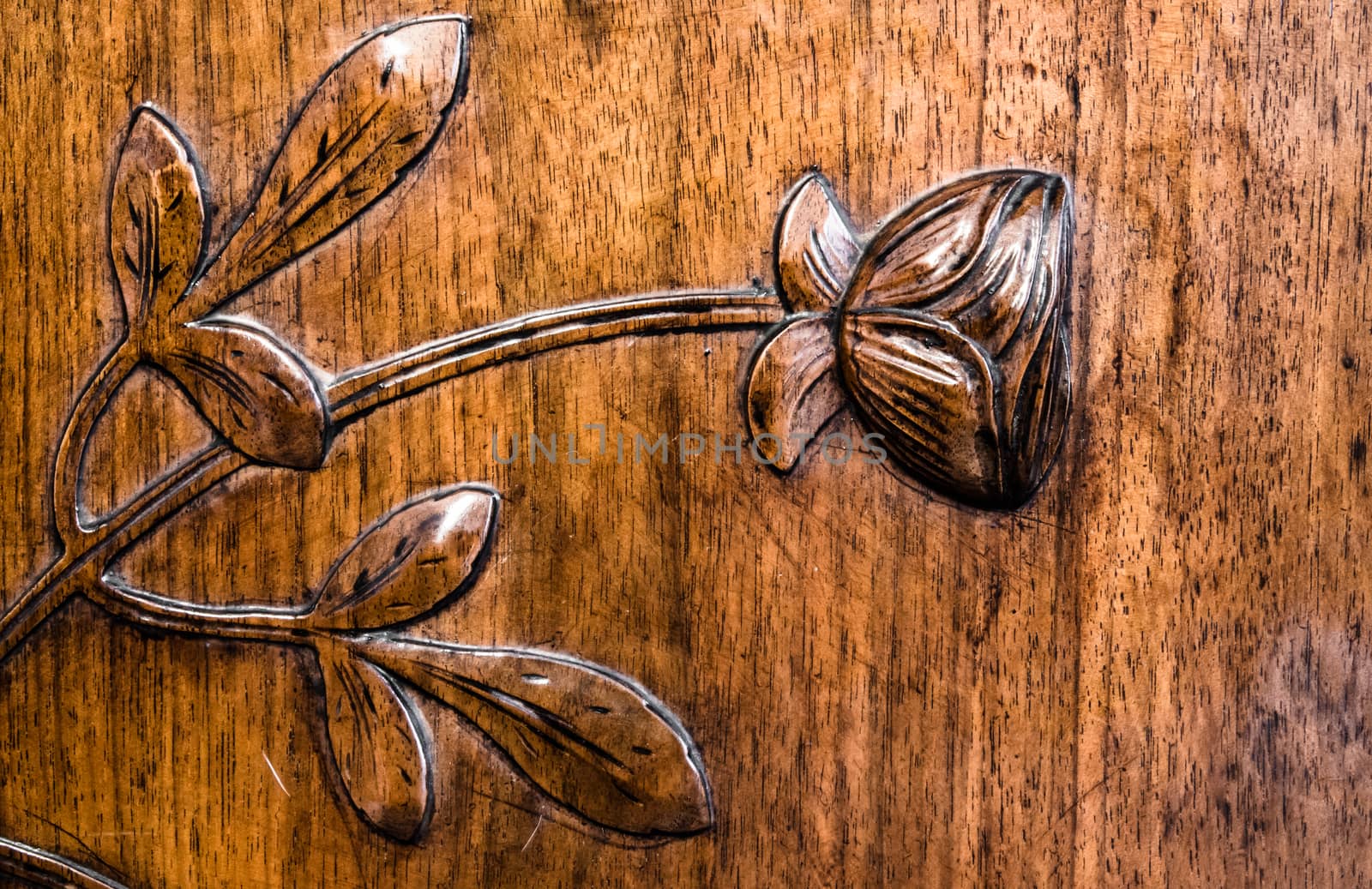 leaves and flowers carved in the wood of an antique dresser