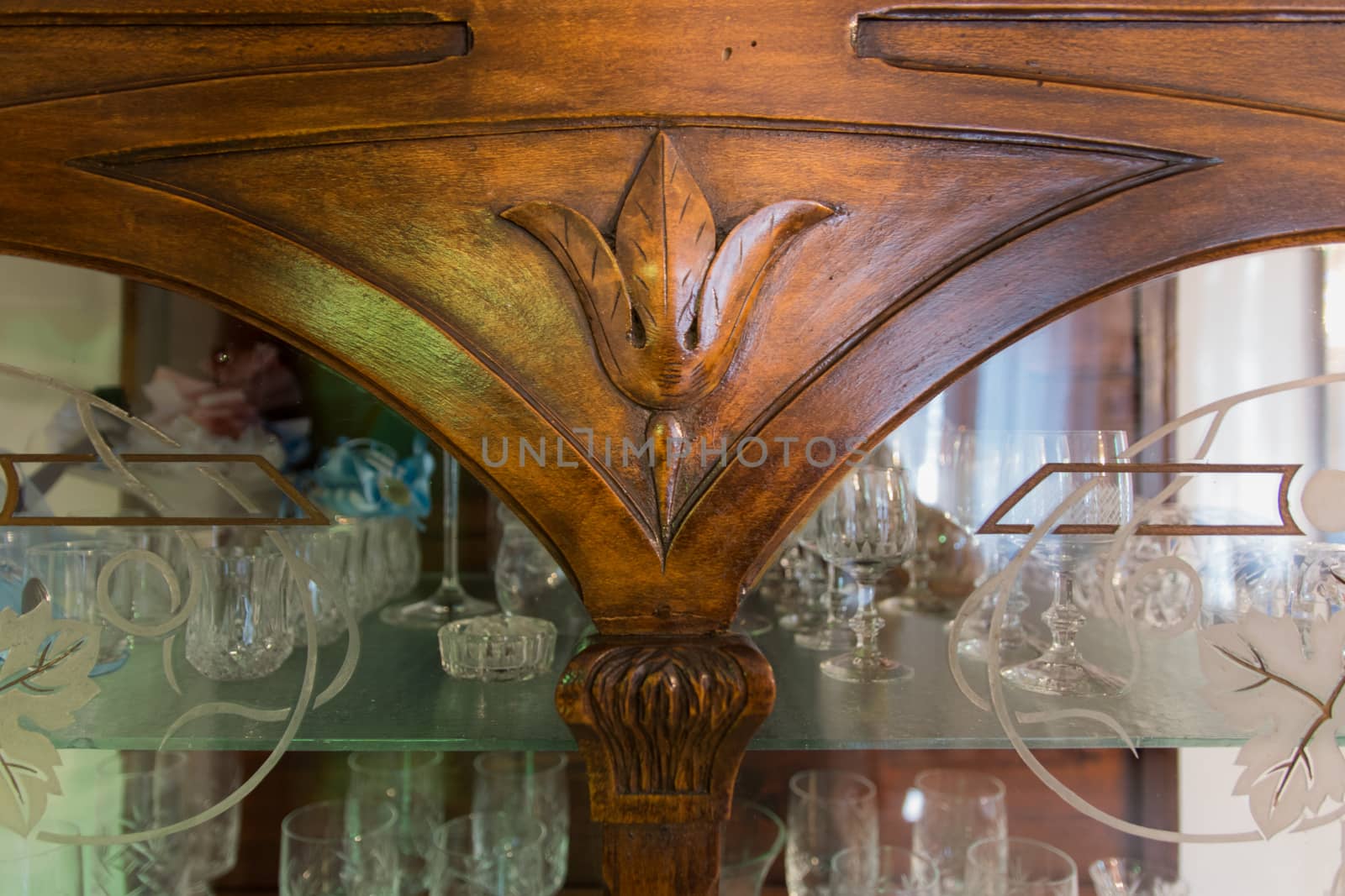 detail of an old carved wood cabinet crystals