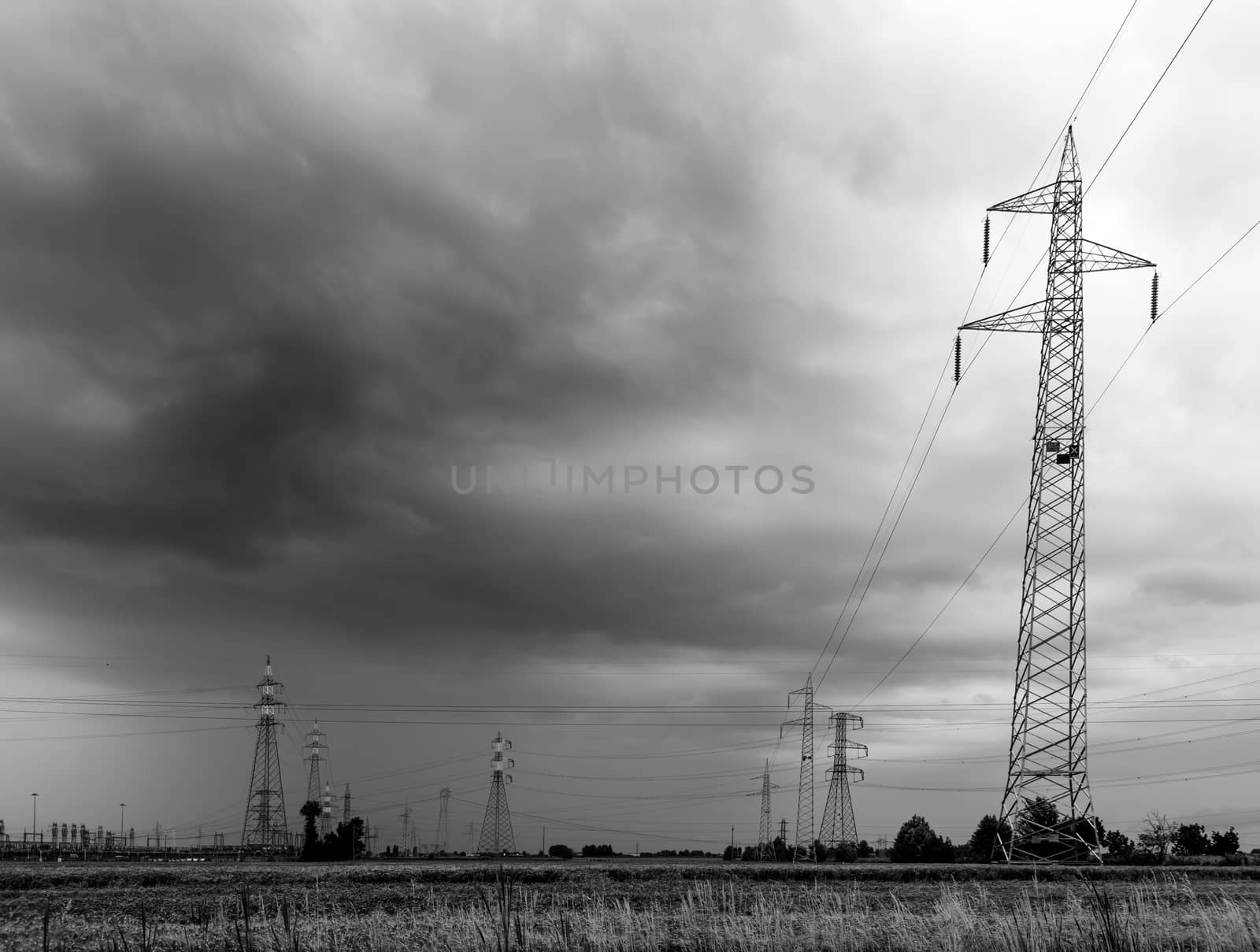 voltage pylons during a thunderstorm by Isaac74