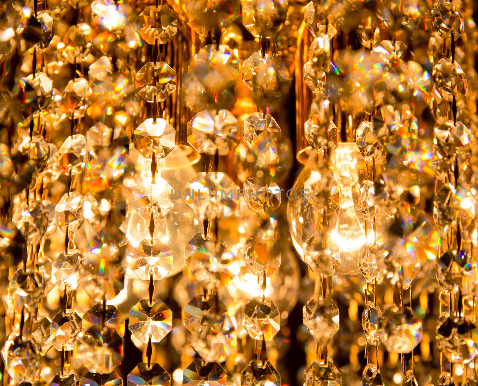 background created by a crystal chandelier that shines with golden light