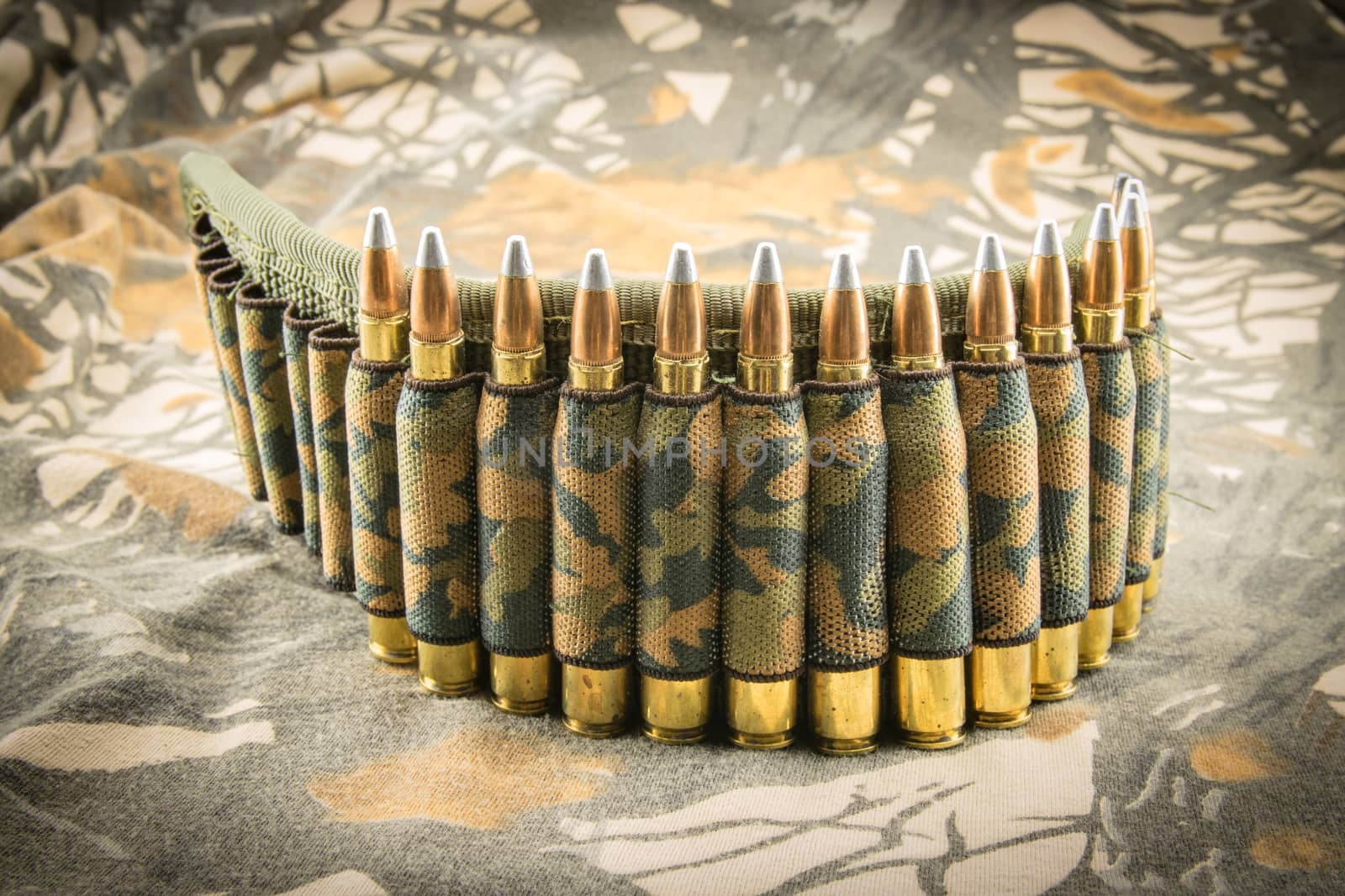 camouflage ammunition belt for rifle on camouflage background