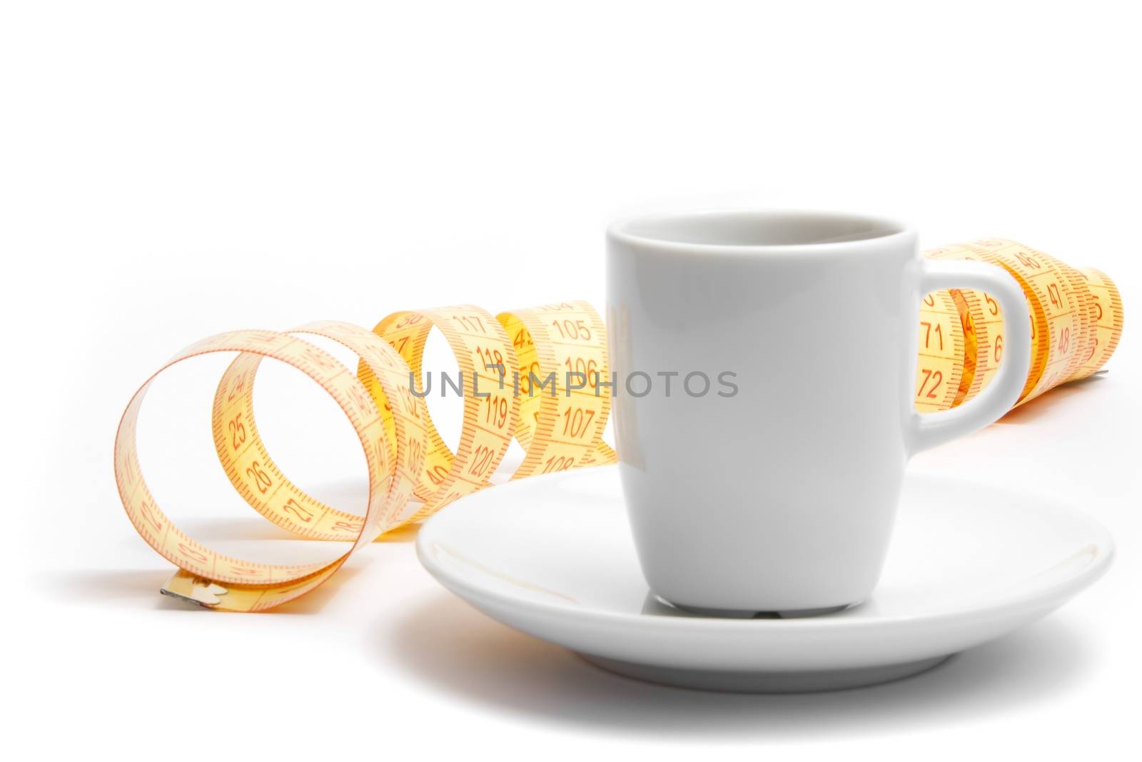 coffee cup with tape measure on white background