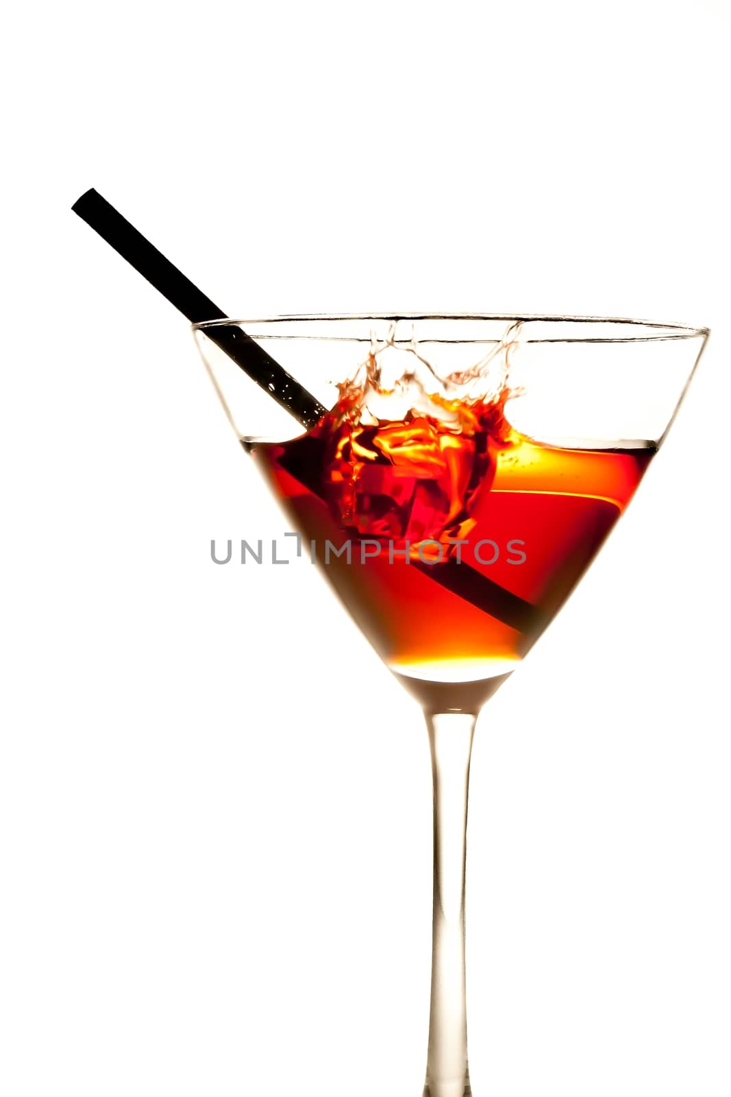 red cocktail with splash and straw on white background