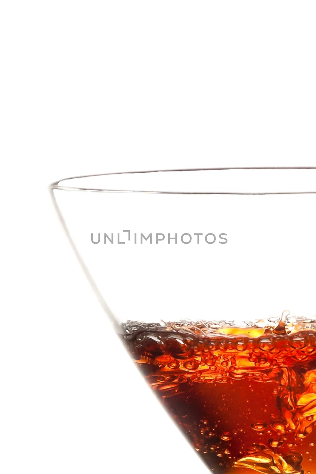 half glass with red cocktail on white background