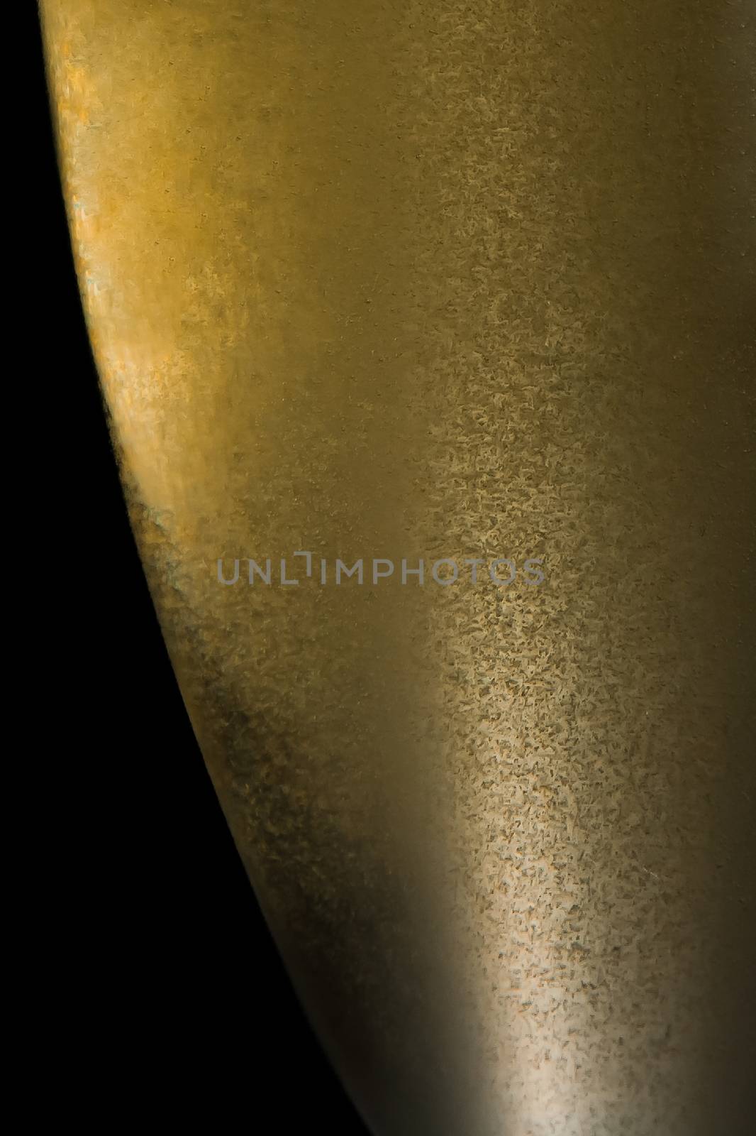 half champagne flute with gold fine bubbles on black background