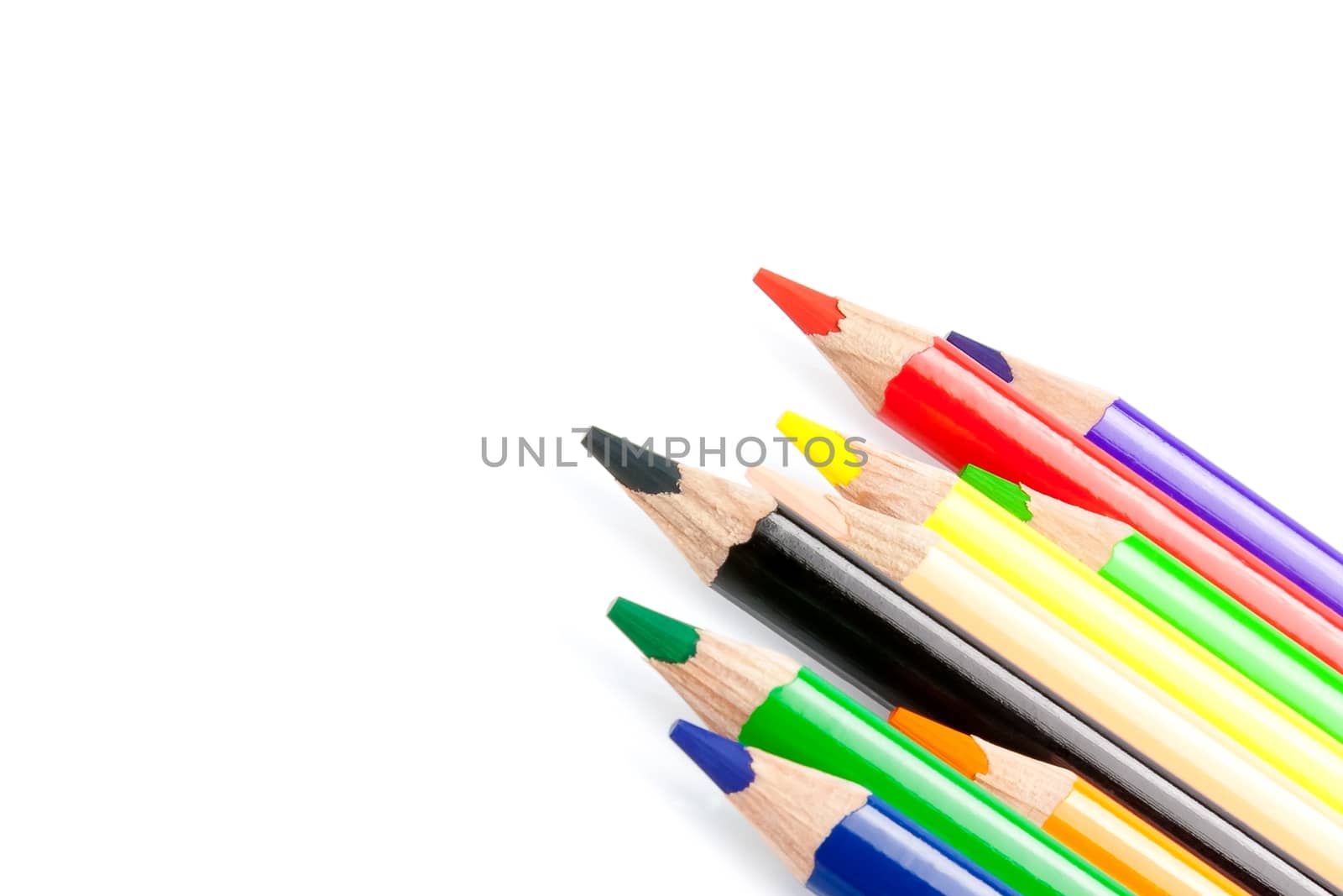 close up of a colorful pencils in a corner on white background