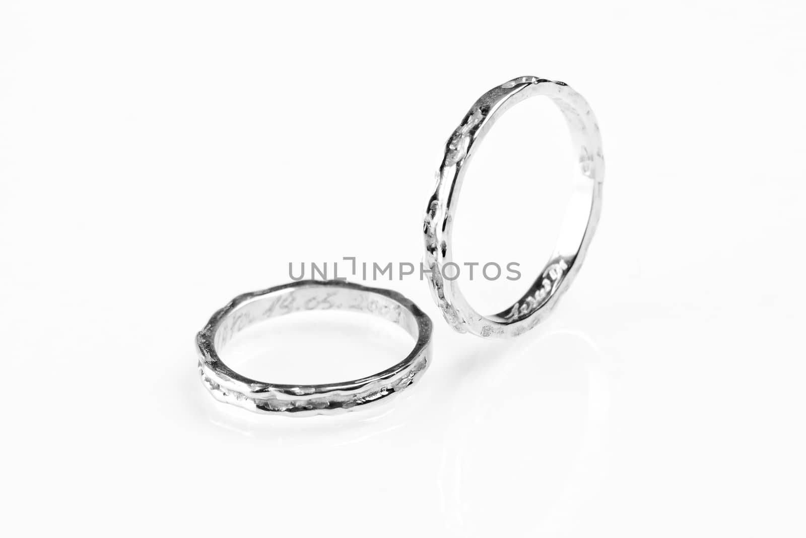 two white gold rings on white background