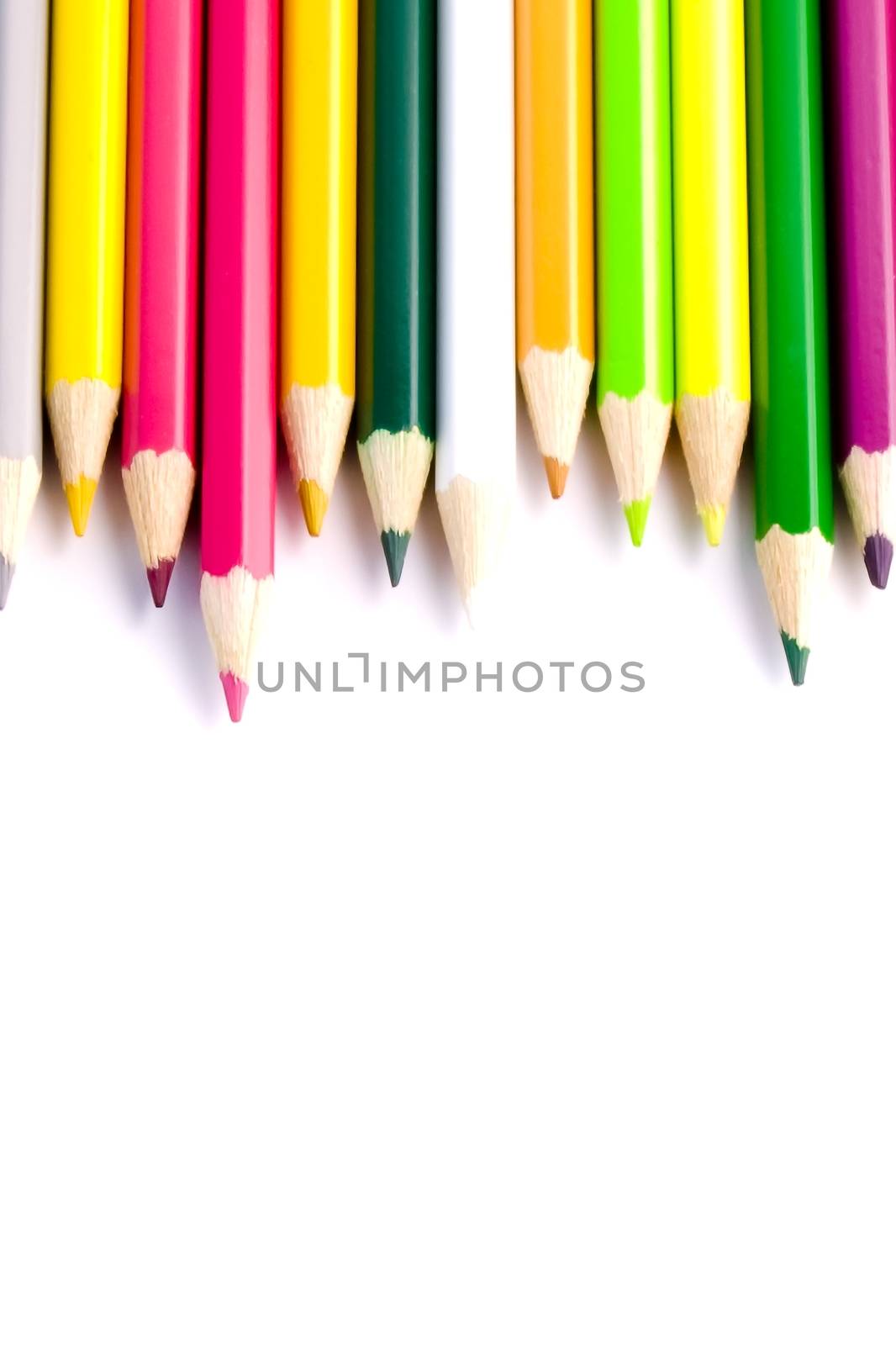 colour pencils on white background close up by donfiore