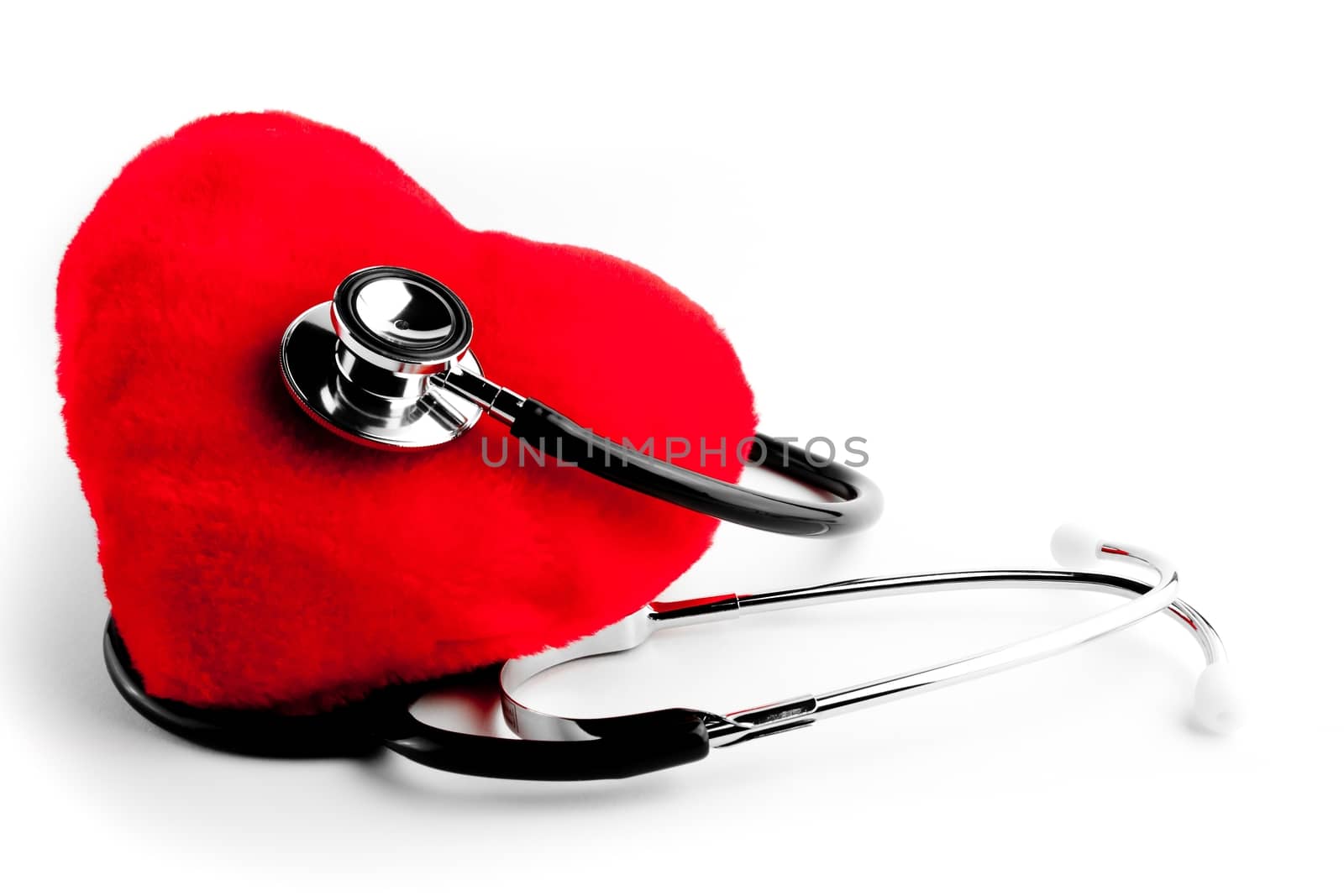 close up of a stethoscope and heart on white background