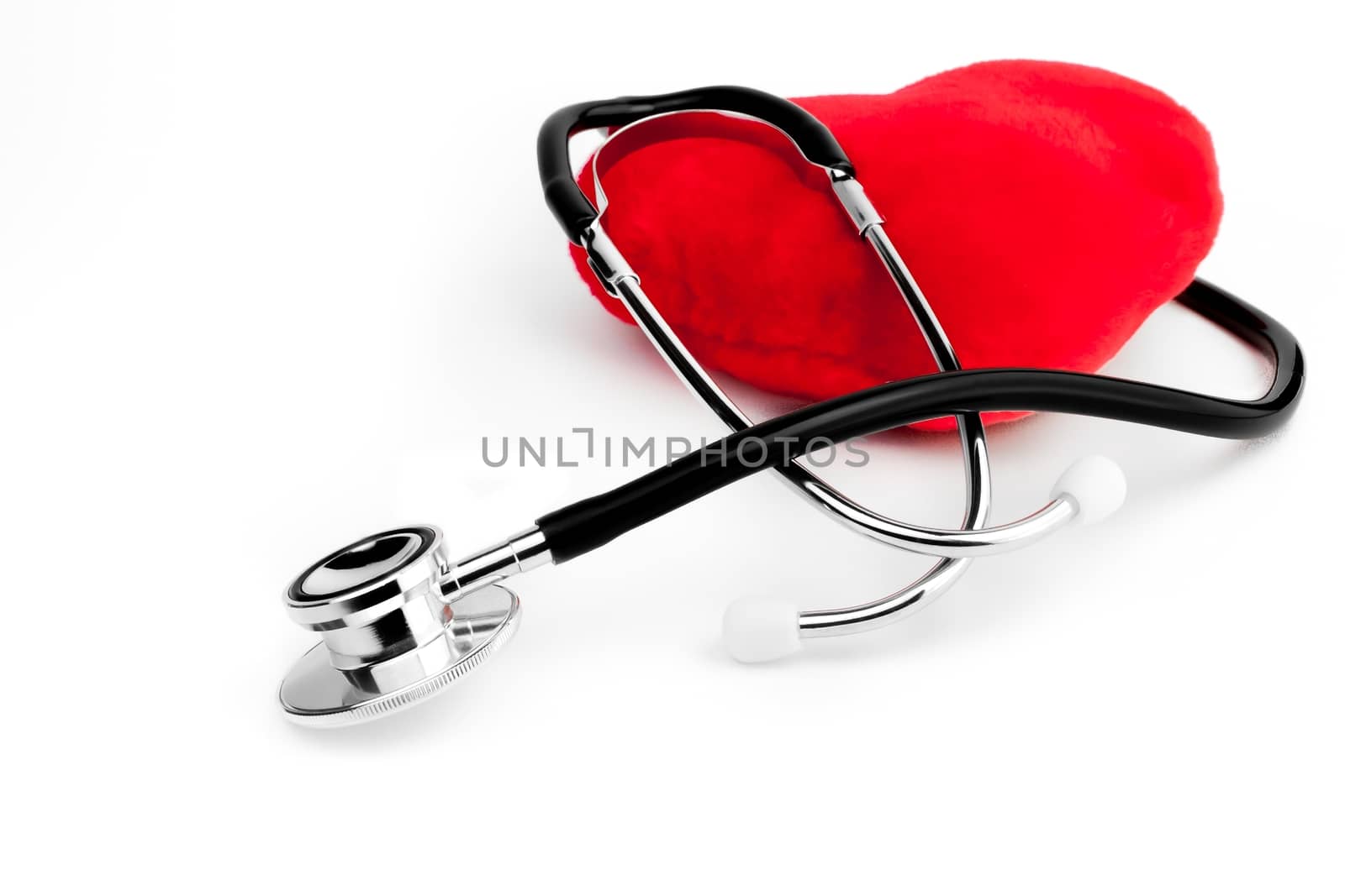 close up of a stethoscope on heart on white background