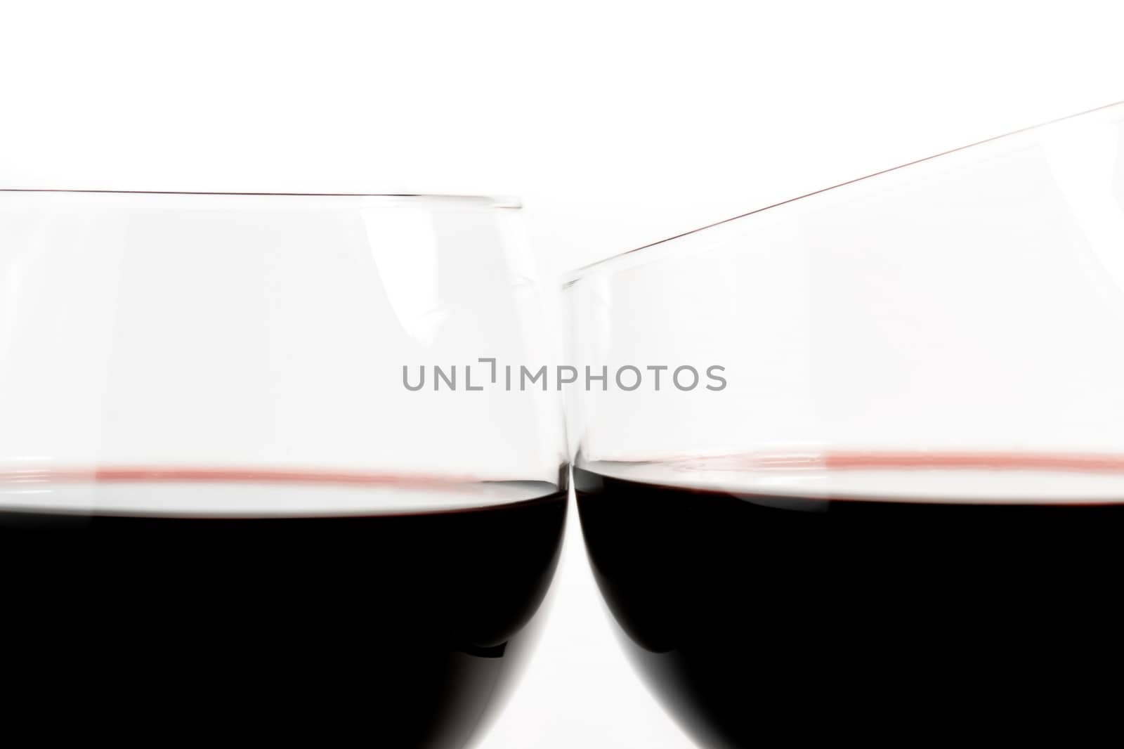 two glasses of wine make cheers on white background