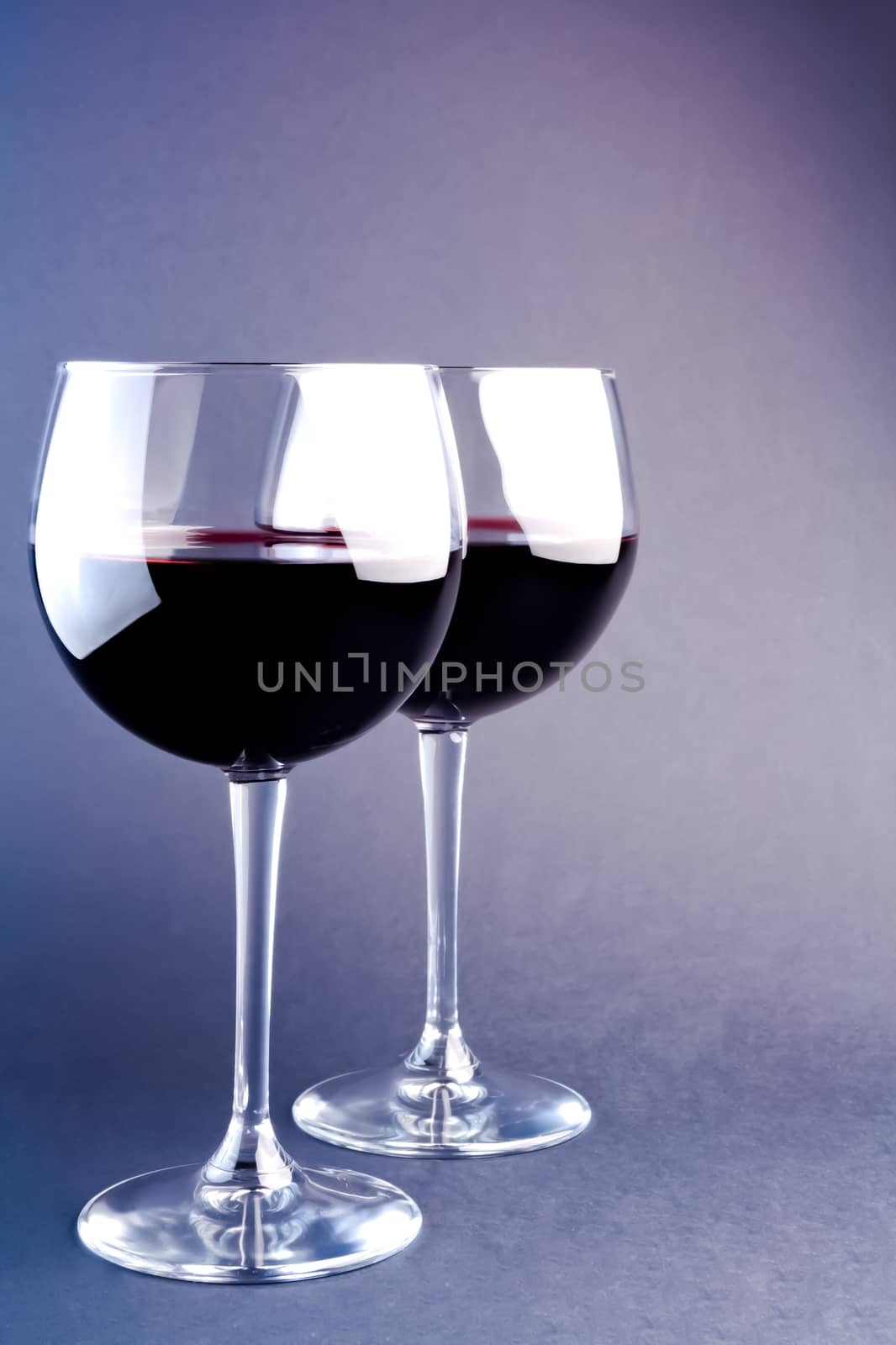 glasses of wine on a light purple background