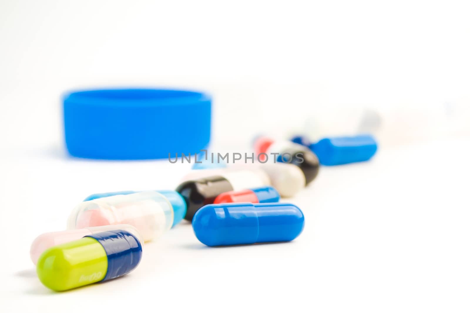 closeup of colored pills on white background