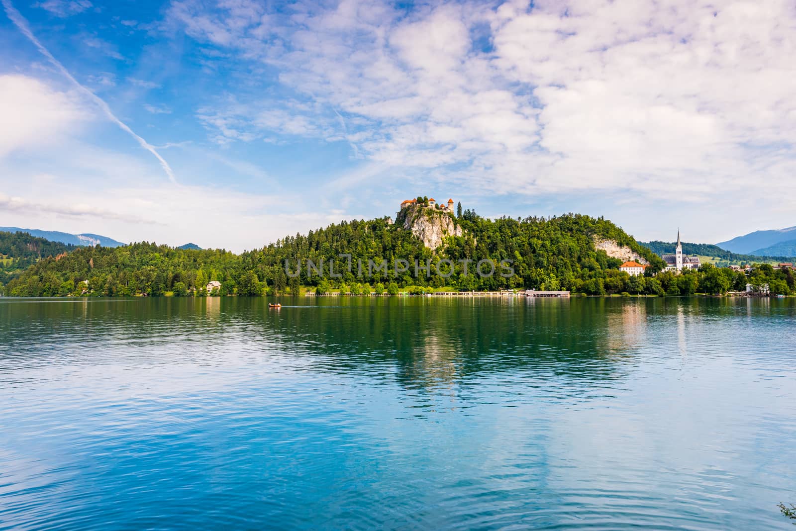 Bled Castle on a Rock at Bled Lake in Slovenia Reflected on Water Surface with Cloudy Sky