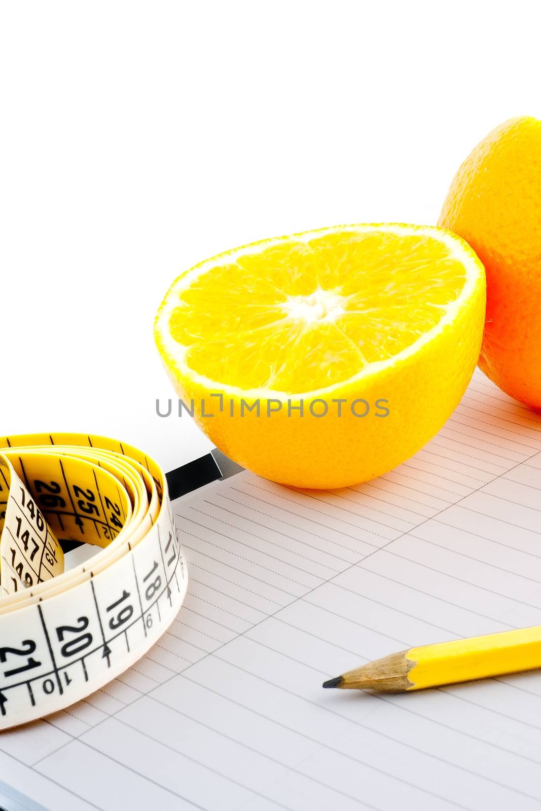 detail an orange with a measuring tape on notepad