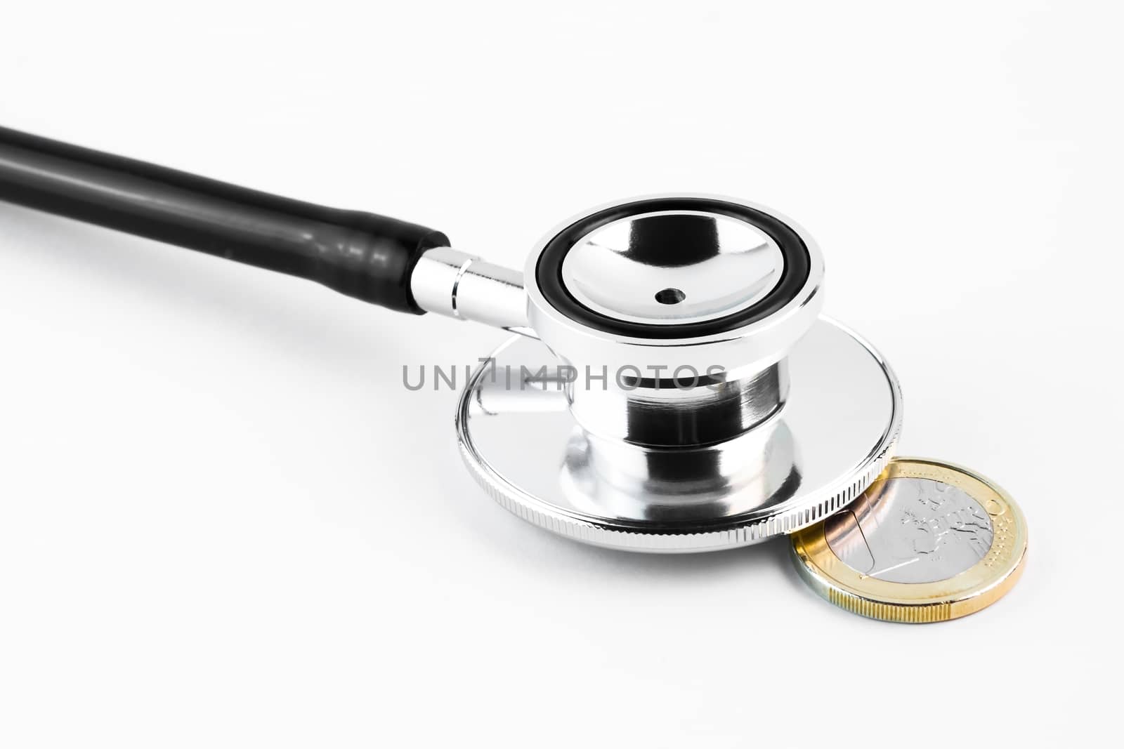 detail of a stethoscope on euro coin on white background