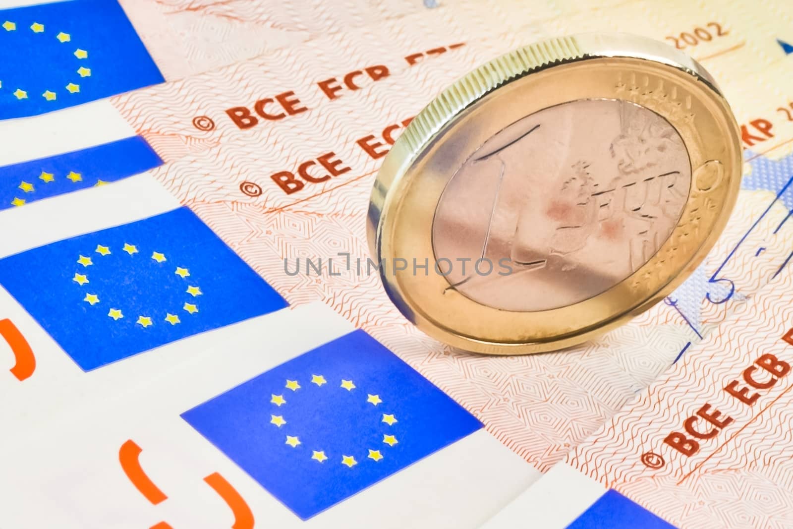 detail of euro coin on 50-euro banknotes
