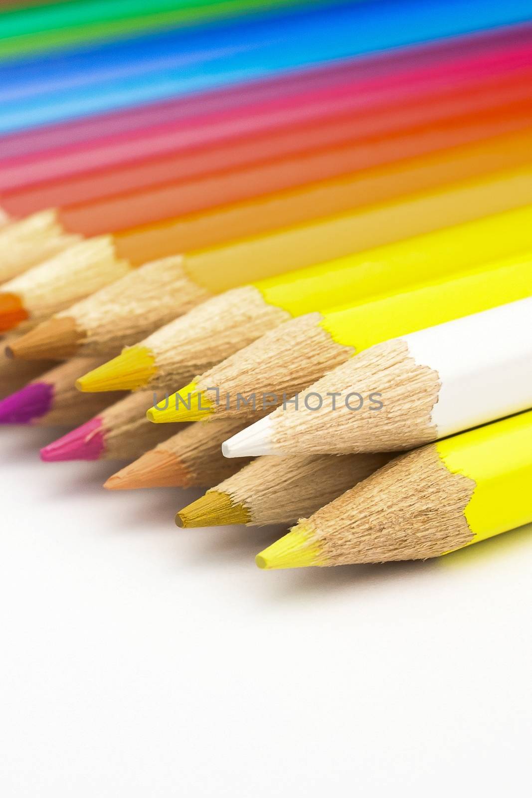 detail view of many colored pencils on white background