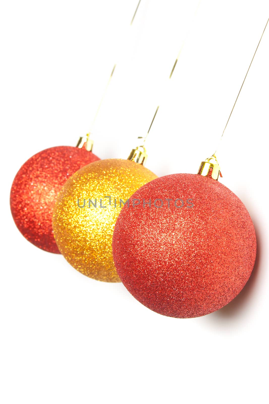 gold and red Christmas balls hanging on white