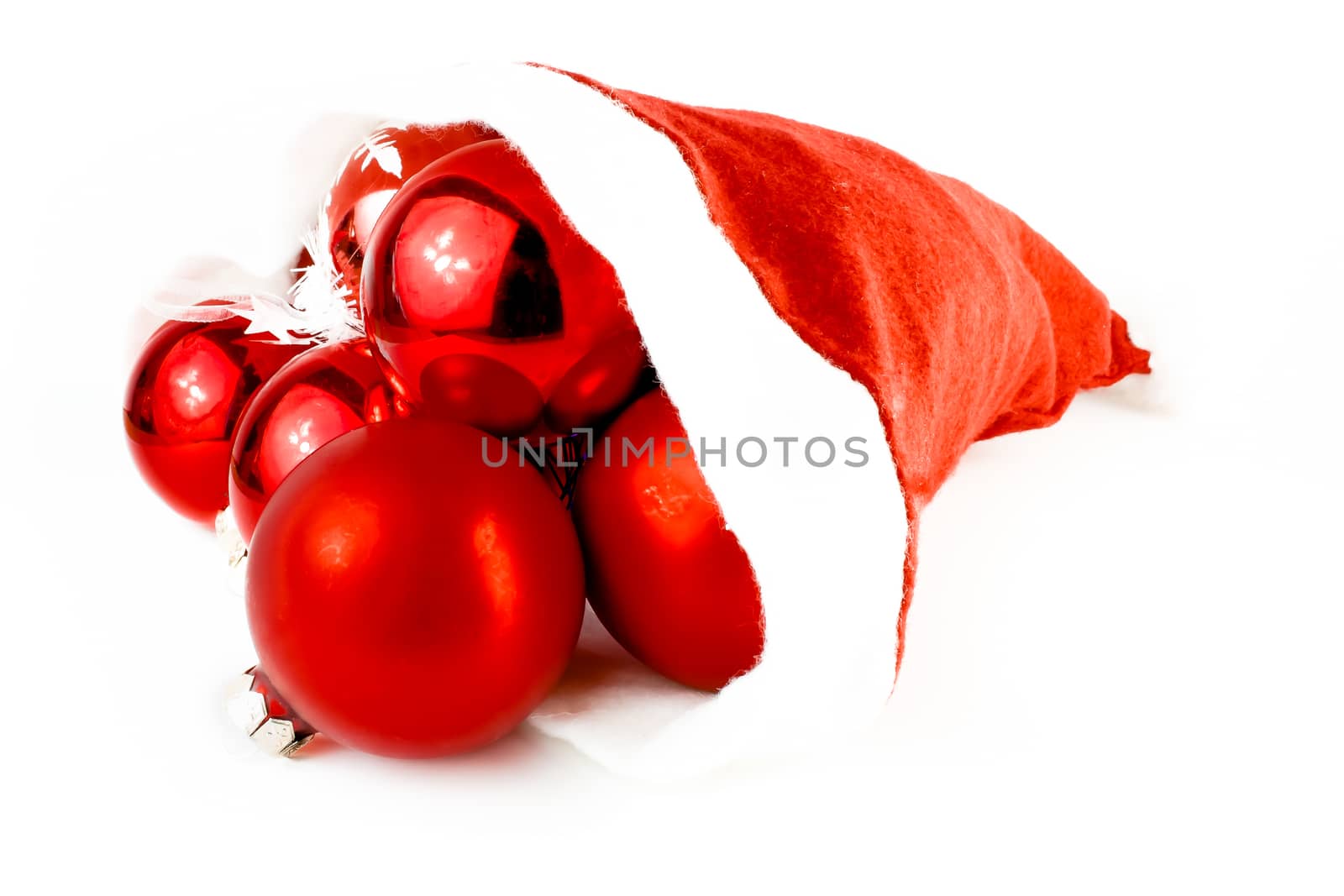 christmas hat full of decorative balls on white background