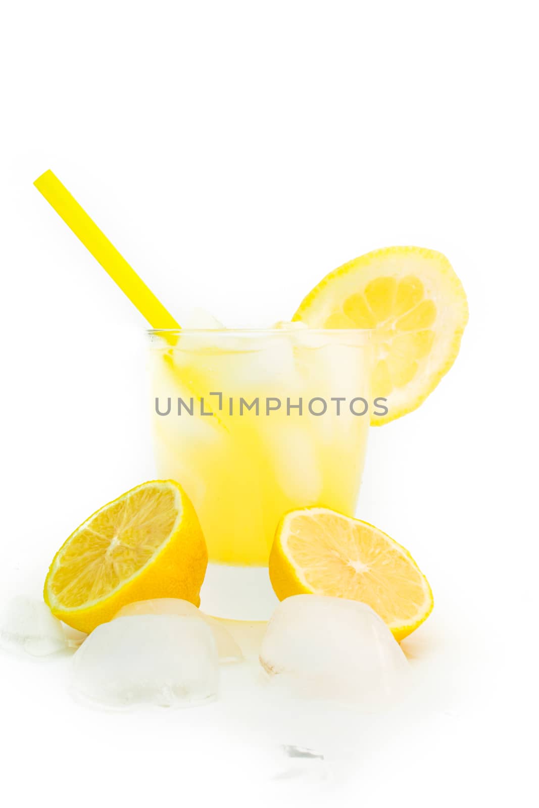 detail of an lemon with a straw, ice and glass