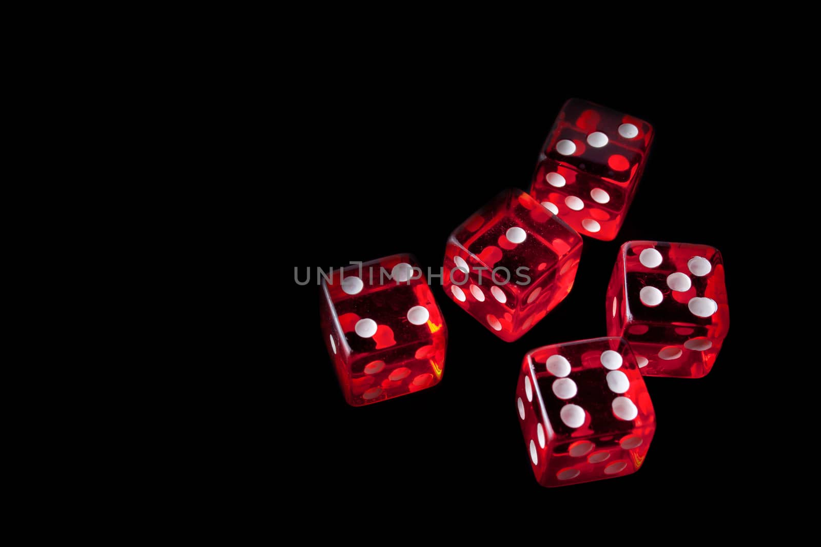 5 red dice in a corner on black background