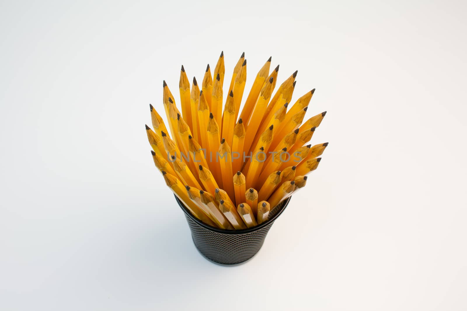 Detail view of a container filled with pencils taken in a office
