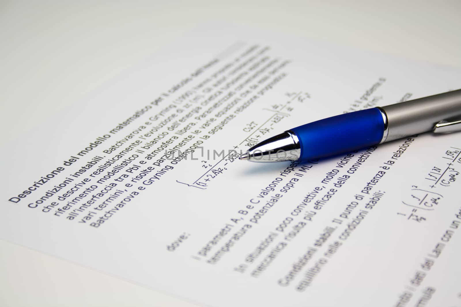 Detail view of  scientific paper image with a pen lying