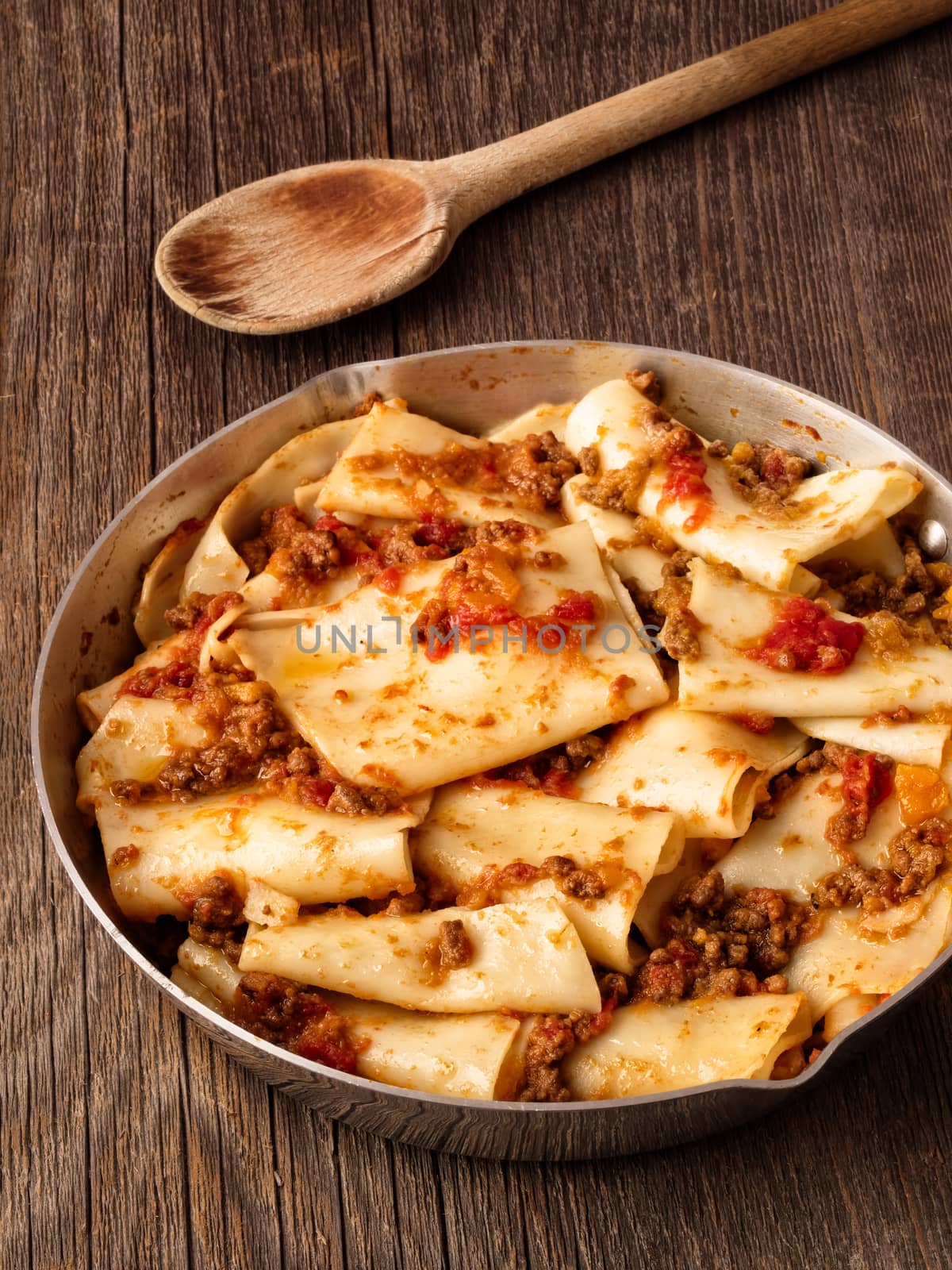 close up of rustic italian pasta in ragu sauce