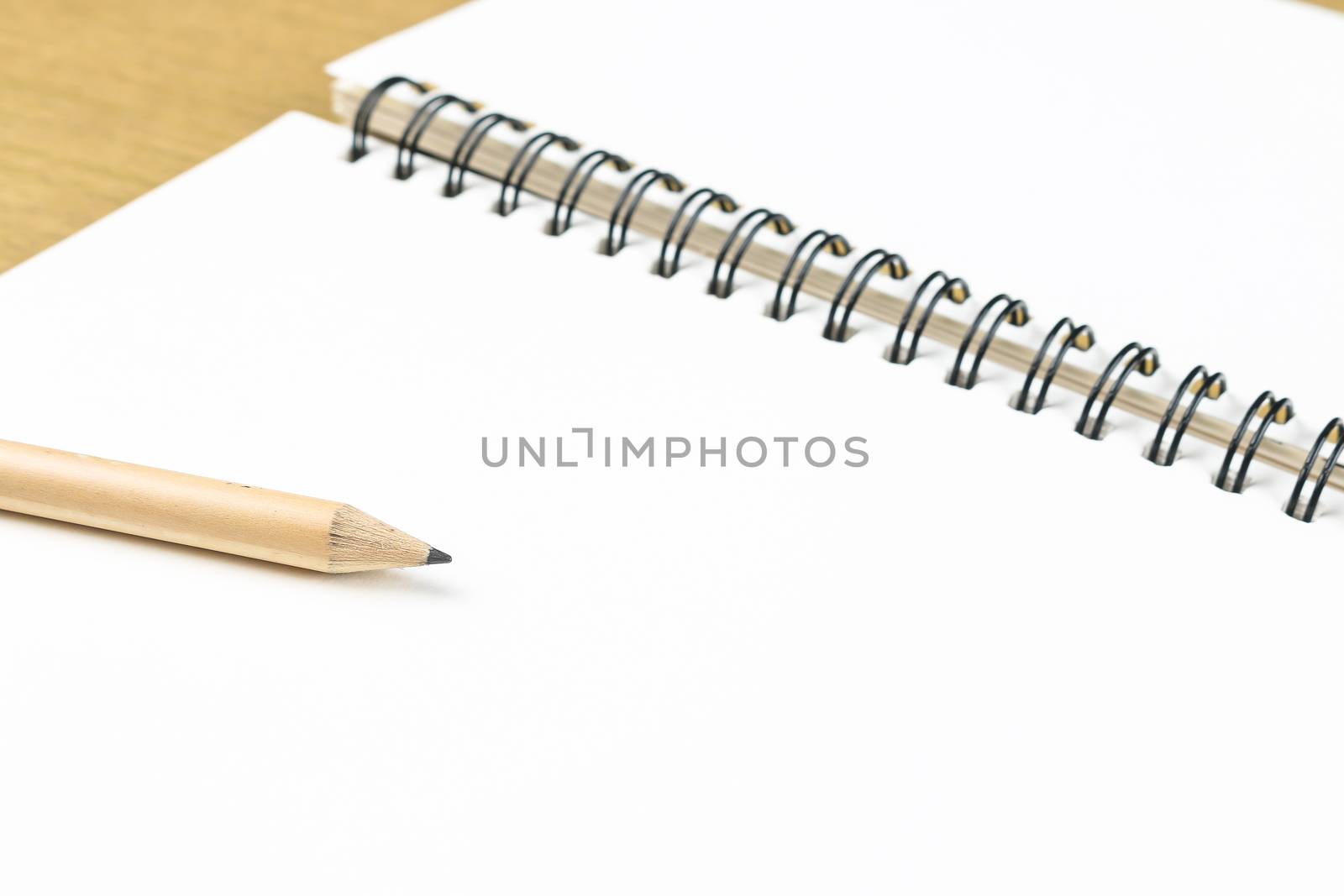 empty pages of opened notebook with pencil by simpleBE