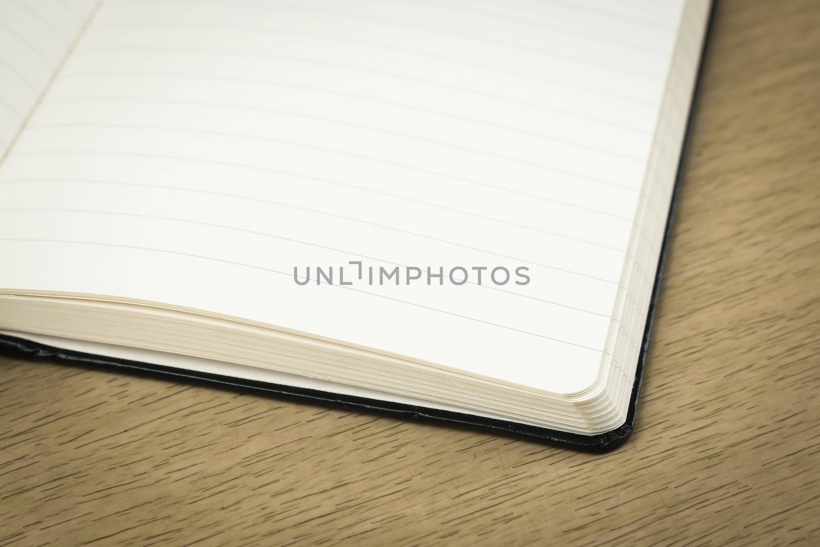 empty pages of opened notebook on wooden table by simpleBE