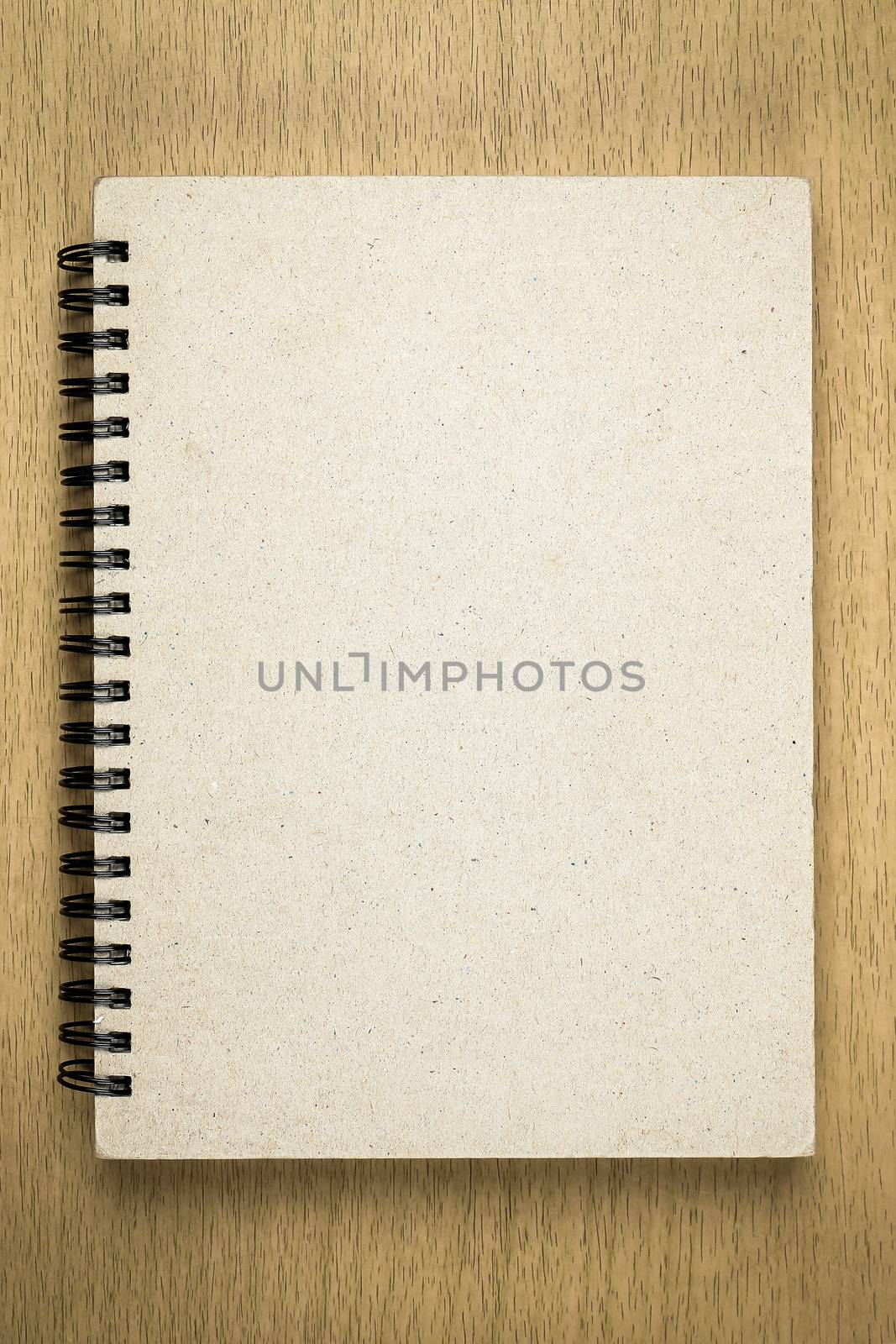 brown notebook or sketchbook on wooden table by simpleBE