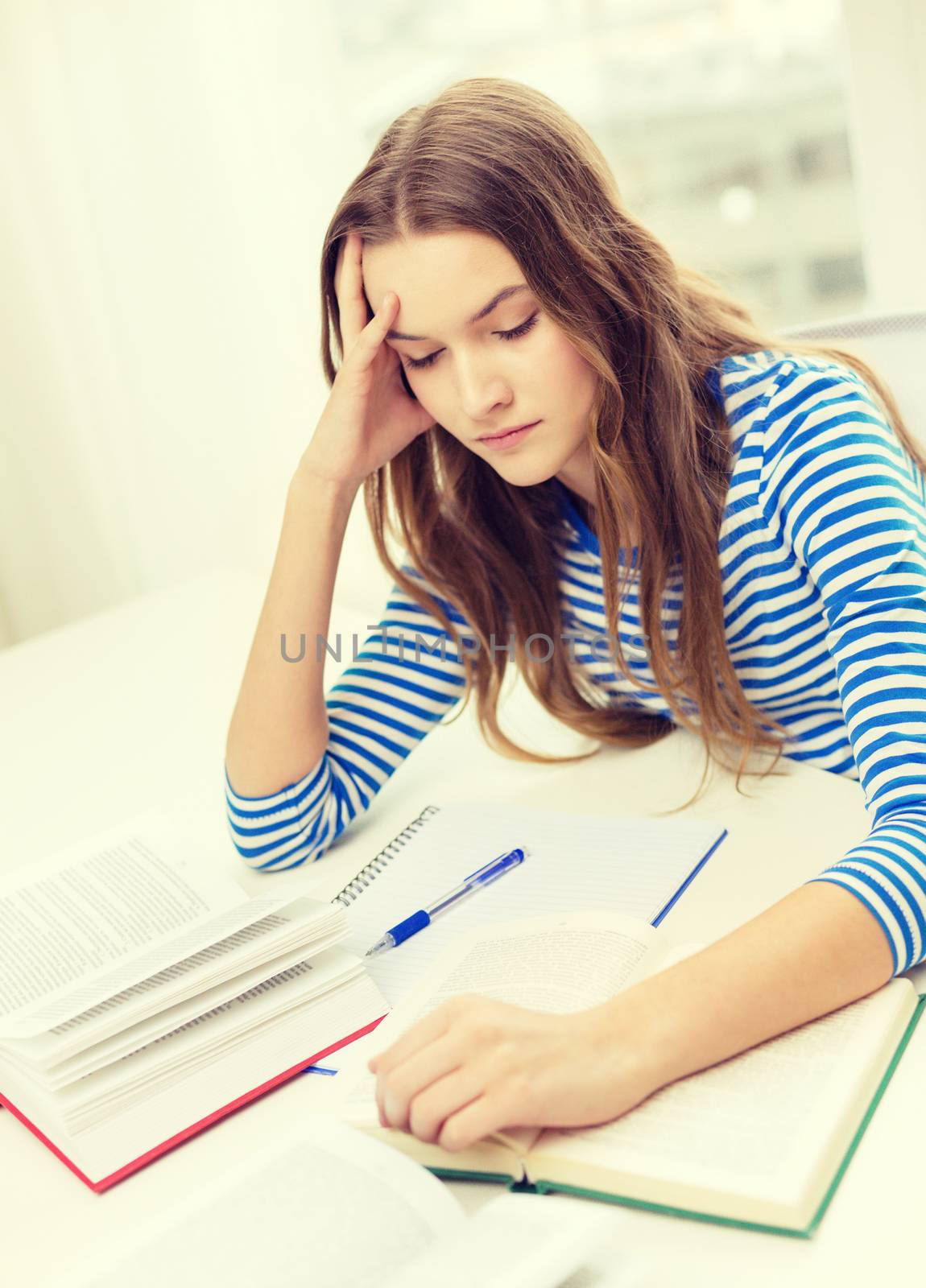 education and home concept - stressed student girl with books